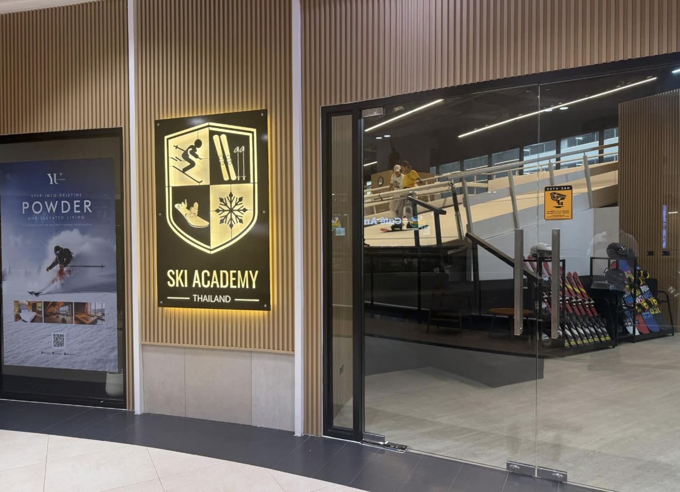 The SKI Academy Thailand shopfront on the 2nd floor of The Ninth Towers, with the slope visible through the glass