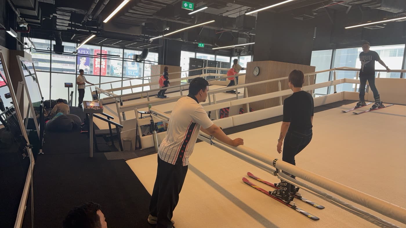 Skiers training on the moving slope at SKI Academy Thailand